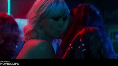 Charlize Theron and Sophia Boutella kissing