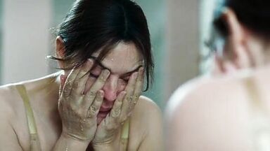 Monica undresses in a public bathroom