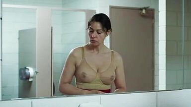 Monica undresses in a public bathroom