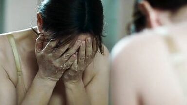 Monica undresses in a public bathroom