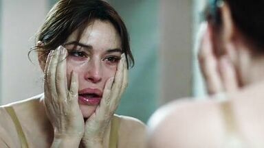 Monica undresses in a public bathroom