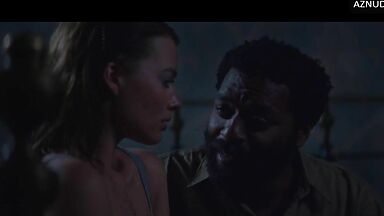 Wild kisses between Margot Robbie and a black man