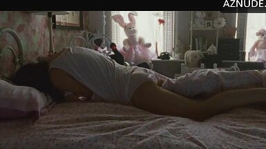 She masturbates in bed thinking she is alone in the room