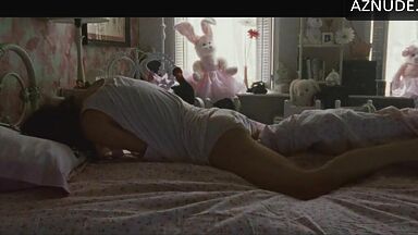 She masturbates in bed thinking she is alone in the room