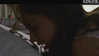 She masturbates in bed thinking she is alone in the room