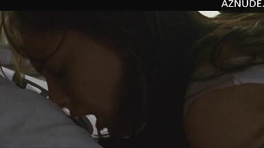 She masturbates in bed thinking she is alone in the room