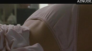 She masturbates in bed thinking she is alone in the room