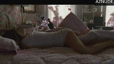 She masturbates in bed thinking she is alone in the room