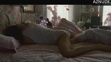 She masturbates in bed thinking she is alone in the room