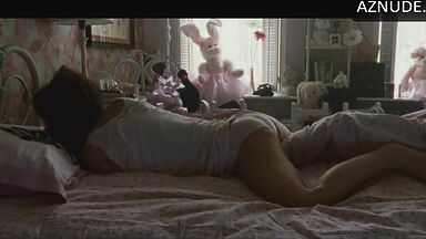 She masturbates in bed thinking she is alone in the room