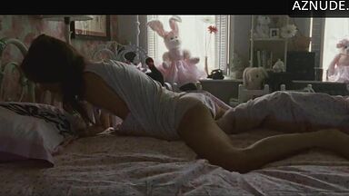 She masturbates in bed thinking she is alone in the room