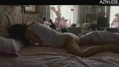 She masturbates in bed thinking she is alone in the room