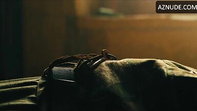 Margot flexes her leg to free herself