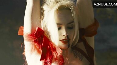 Margot flexes her leg to free herself