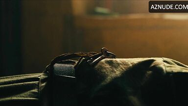 Margot flexes her leg to free herself