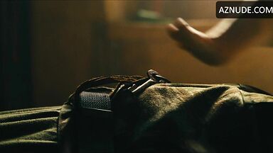 Margot flexes her leg to free herself