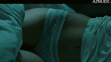 In underwear with the duvet on her