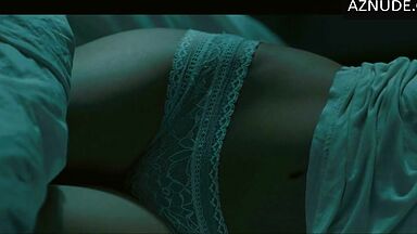 In underwear with the duvet on her