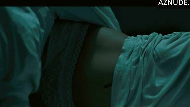 In underwear with the duvet on her