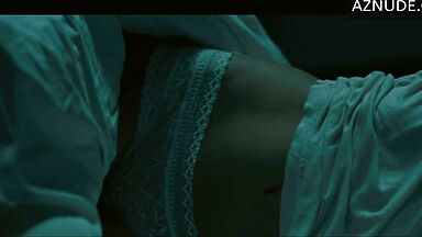 In underwear with the duvet on her