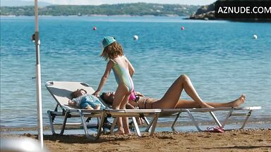 Wet in a swimsuit on a sun lounger