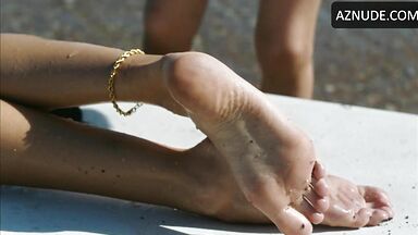 Wet in a swimsuit on a sun lounger