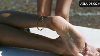 Wet in a swimsuit on a sun lounger