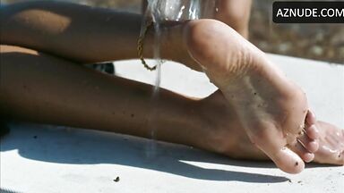 Wet in a swimsuit on a sun lounger