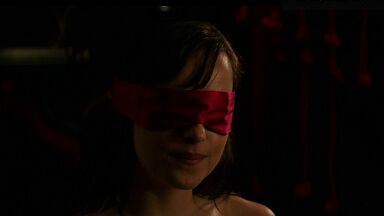 Blindfolded and handcuffed she has no escape