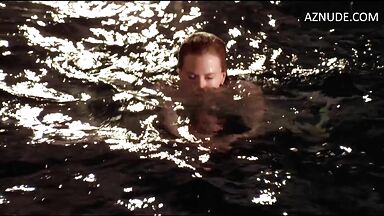 She comes out of the water with wet tits