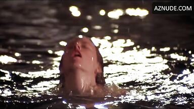 She comes out of the water with wet tits