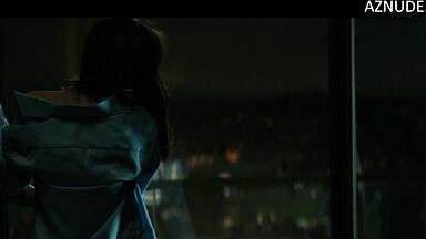 She goes out onto the balcony with her breasts bare