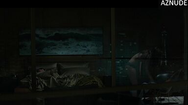 She goes out onto the balcony with her breasts bare