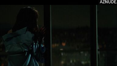 She goes out onto the balcony with her breasts bare