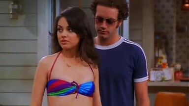 Mila Kunis in a swimsuit with her redhead friend