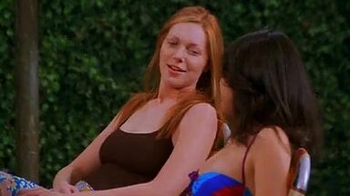 Mila Kunis in a swimsuit with her redhead friend