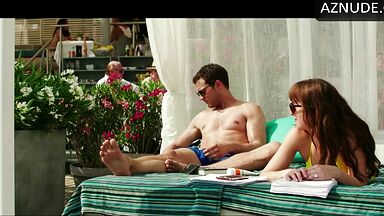 Dakota Johnson takes off her swimsuit
