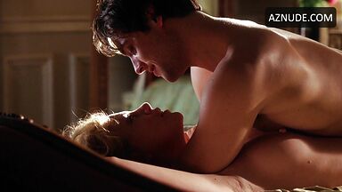 Charlize Theron she is being ridden by a man