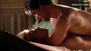 Charlize Theron she is being ridden by a man