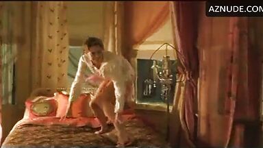 Charlize Theron having fun at the head of the bed